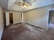 Spacious main bedroom featuring a trey ceiling with ceiling fan and neutral paint at 25 Darcee Ct, Lawrenceville, GA 30046