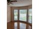Bright sitting area with hardwood floors and three large windows overlooking the front yard at 25 Darcee Ct, Lawrenceville, GA 30046