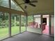 Sunroom with large windows, with views of the deck and backyard at 25 Darcee Ct, Lawrenceville, GA 30046