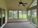 The sunroom features large windows offering scenic views, with a ceiling fan for comfort at 25 Darcee Ct, Lawrenceville, GA 30046