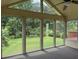 A sunroom boasts floor-to-ceiling windows with views of the verdant backyard at 25 Darcee Ct, Lawrenceville, GA 30046