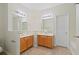 Bright bathroom featuring double vanities, neutral tile flooring, and ample lighting at 3300 Suttles Sw Dr, Atlanta, GA 30331