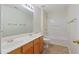 Bathroom with a double sink vanity, toilet, shower and bathtub combination at 3300 Suttles Sw Dr, Atlanta, GA 30331