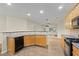 Bright kitchen featuring a breakfast bar, wood cabinetry, and modern appliances at 3300 Suttles Sw Dr, Atlanta, GA 30331