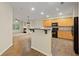 Open kitchen featuring wood cabinets, black appliances, and views of the living room at 3300 Suttles Sw Dr, Atlanta, GA 30331