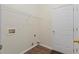 A practical laundry area with a wire shelf above the connections and a nearby door at 3300 Suttles Sw Dr, Atlanta, GA 30331