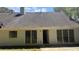 Exterior view of backyard featuring sliding glass doors and a well-maintained roof at 3510 Hog Mountain Rd, Dacula, GA 30019