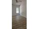 Bright bedroom with light walls, wood-look flooring, a ceiling fan and a large window at 3510 Hog Mountain Rd, Dacula, GA 30019