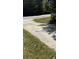 Image of a concrete driveway and a patch of grass next to a road at 3510 Hog Mountain Rd, Dacula, GA 30019