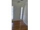 Bright entryway with hardwood floors, a white door, and sidelight windows at 3510 Hog Mountain Rd, Dacula, GA 30019