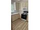 Well-lit kitchen with modern appliances, white cabinets, and wood-look flooring at 3510 Hog Mountain Rd, Dacula, GA 30019