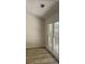 Living area boasting new flooring and expansive windows that fill the space with light at 3510 Hog Mountain Rd, Dacula, GA 30019