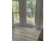 Sun-lit room with new floors and large windows providing ample natural light and outdoor views at 3510 Hog Mountain Rd, Dacula, GA 30019