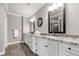 Bathroom featuring double vanity with granite counters, framed mirrors, hardwood floors, and modern fixtures at 406 Mareeba Park # 61, Canton, GA 30114