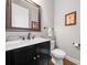 Well-lit powder room with a modern vanity, marble countertop, and elegant mirror, offering convenience and style at 406 Mareeba Park # 61, Canton, GA 30114