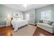 Bright bedroom featuring hardwood floors, a comfortable couch, neutral colors, and plantation shutters at 406 Mareeba Park # 61, Canton, GA 30114