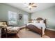 Comfortable bedroom with a woven bed, ceiling fan, two windows, and hardwood floors at 406 Mareeba Park # 61, Canton, GA 30114