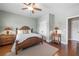 Relaxing bedroom with a ceiling fan, woven bed, hardwood floors, and neutral color scheme at 406 Mareeba Park # 61, Canton, GA 30114