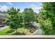 Exterior view of complex with beautiful trees, landscaping and street at 406 Mareeba Park # 61, Canton, GA 30114