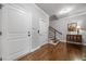 Welcoming entryway with hardwood floors, a staircase, and a storage cabinet with décor at 406 Mareeba Park # 61, Canton, GA 30114