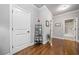 Hallway boasting a decorative shelf with photos and a door leading to a modern bathroom at 406 Mareeba Park # 61, Canton, GA 30114