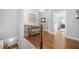 Upstairs hallway with hardwood floors and a view of the entryway through the railing at 406 Mareeba Park # 61, Canton, GA 30114