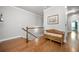 Hallway featuring hardwood floors and a decorative bench along the railing at 406 Mareeba Park # 61, Canton, GA 30114
