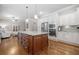 Modern kitchen featuring a kitchen island, stainless steel appliances, and white cabinets, designed for convenience and style at 406 Mareeba Park # 61, Canton, GA 30114
