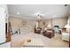 Spacious living room with neutral colored walls, carpet, seating, ceiling fan and white trim at 406 Mareeba Park # 61, Canton, GA 30114