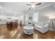 Open-concept living room with kitchen view, hardwood floors, white cabinetry, and modern lighting fixtures at 406 Mareeba Park # 61, Canton, GA 30114