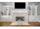 Living room with fireplace, built-in shelving, and a mounted television for optimal entertainment and storage at 406 Mareeba Park # 61, Canton, GA 30114