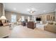 Bright living room with neutral tones, ceiling fan, two leather chairs and white built-in entertainment center at 406 Mareeba Park # 61, Canton, GA 30114