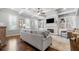 Bright living room with hardwood floors, fireplace, built-in shelving, and stylish furnishings, perfect for relaxation at 406 Mareeba Park # 61, Canton, GA 30114