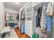 Walk-in closet with organized shelving, hanging racks, and hardwood flooring for optimal storage at 406 Mareeba Park # 61, Canton, GA 30114