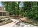 Backyard with wooden deck and patio, overlooking mature trees and landscaping at 251 Waller Nw Cir, Marietta, GA 30064