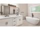 Modern primary bathroom featuring double sink vanity, soaking tub, and large mirror at 251 Waller Nw Cir, Marietta, GA 30064
