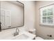 Stylish powder room featuring modern fixtures and a sleek mirror at 251 Waller Nw Cir, Marietta, GA 30064
