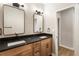 Modern bathroom features double vanity with black countertop, framed mirrors, and updated fixtures at 251 Waller Nw Cir, Marietta, GA 30064
