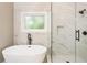 Spa-like bathroom features soaking tub and glass enclosed shower with sleek black hardware at 251 Waller Nw Cir, Marietta, GA 30064