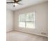 Bright bedroom showcases large window, ceiling fan, neutral carpet, and fresh paint at 251 Waller Nw Cir, Marietta, GA 30064
