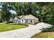 Side view of a white brick home showing a three car garage and driveway at 251 Waller Nw Cir, Marietta, GA 30064