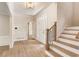 Entryway with hardwood floors, stairs with black metal railings, and modern lighting at 251 Waller Nw Cir, Marietta, GA 30064