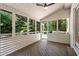 Relaxing screened porch with wooden floors, ceiling fan, and views of lush greenery at 251 Waller Nw Cir, Marietta, GA 30064