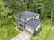 An aerial view of a modern two-story home with mature trees and well manicured lawn at 2638 Clairmont Rd, Atlanta, GA 30329