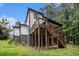 The back of the house features a beautiful deck and stairs to the green backyard at 2638 Clairmont Rd, Atlanta, GA 30329
