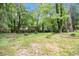 This backyard boasts luscious green grass and abundant shade trees perfect for outdoor relaxation at 2638 Clairmont Rd, Atlanta, GA 30329