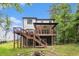 Backyard view features a two-story deck, fire pit, and wooded surroundings, perfect for outdoor relaxation and entertaining at 2638 Clairmont Rd, Atlanta, GA 30329