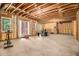 Unfinished basement space with exposed beams, great natural light, and potential for customization at 2638 Clairmont Rd, Atlanta, GA 30329