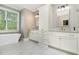 Stylish bathroom boasts a soaking tub, dual vanity sinks with granite countertops and gray wood-look tile at 2638 Clairmont Rd, Atlanta, GA 30329