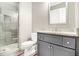 Bathroom featuring a glass shower, gray vanity with a marble countertop, and a toilet at 2638 Clairmont Rd, Atlanta, GA 30329